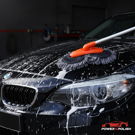 Chenille car wash mop in action on foam-covered black car — Power & Polish